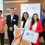HIBAM 核心合作伙伴与 UOW Malaysia 的袋鼠吉祥物合影，象征项目兼具本地影响力与全球视野的融合。